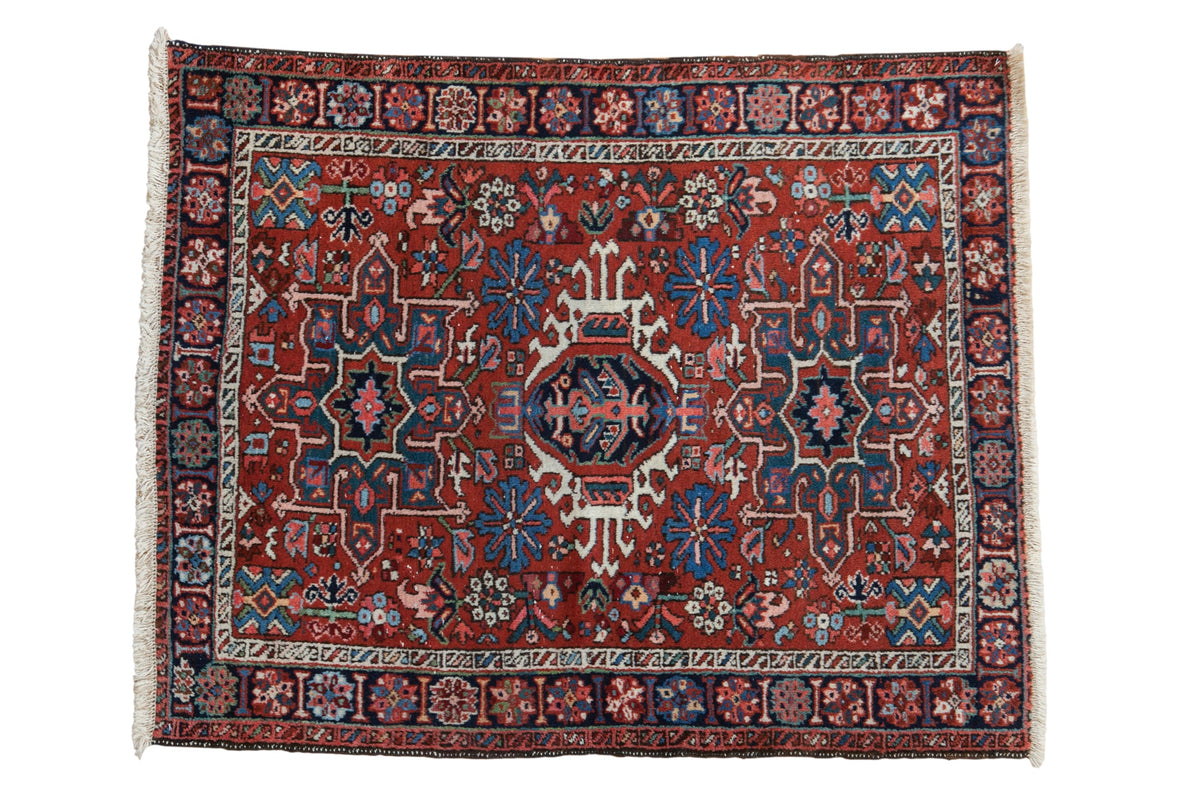 Vintage Karaja square rug with a triple center medallion and geometric floral designs in red, blue, and ivory.