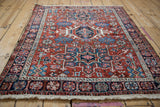 Low angle highlights the varied pile height and geometric design of a Persian Karaja rug.