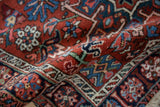 Angled view revealing the plush wool pile and geometric floral design of a vintage Karaja rug.