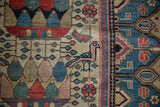 Vintage Malayer rug showing a pink bird, fuchsia florals, and blue geometric border detail.
