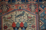 Hand-knotted field with bird, egg, tendril motifs, mostly even wear, fuchsia, sky blue.