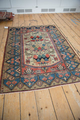 Vintage Malayer rug border with blue germinating plant motif, adjoining blossomed field.