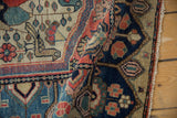 Vintage Malayer rug's textured dark blue border with fuchsia and sky blue motifs.