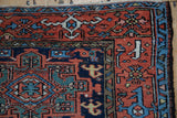 Detail of vintage Karaja rug corner, geometric floral patterns, terra cotta, navy, mallard green.