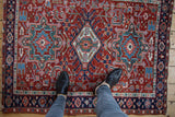 Vintage Karaja rug, cherry red field, triple medallion with navy, green, and blush geometric patterns.