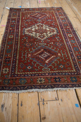 Vintage Karaja rug, black cherry red field with diamond medallions, and hook latch rams horn details.