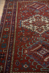 Vintage Karaja rug side cord selvage with geometric patterns in deep red, sapphire blue, and ivory.
