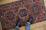 Vintage Karaja rug with geometric triple medallions on a brick red field, navy blue accents.