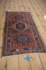 Hand-knotted Vintage Karaja rug detail: secure blue selvage, brick red field, navy floral border.