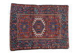 Vintage Karaja rug with triple hook and latch medallion, colorful floral field, red and navy.