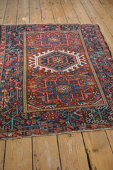 Vintage Karaja rug's intricate floral blossom border and patterned field in cherry red and navy blue.