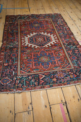 Vintage Karaja rug corner detail, intricate navy blue floral border, and tattered ivory fringe.