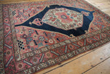 Vintage Malayer rug's serrated leaf main border with checkered details in madder red and dusty blue.