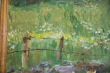 Detail of Grace B. Keogh painting, rustic fence, wire, green field, and wood frame.