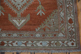 Close-up of the vintage Malayer runner's corner, showing its geometric borders and worn, low-pile texture.