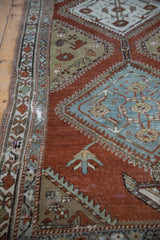 Close-up of the vintage Malayer's distressed border with visible foundation and slate blue motifs.
