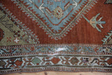 Close-up of the distressed rug pile revealing the foundation on a vintage Malayer runner.