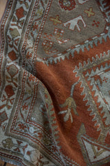 Supple drape on a vintage Persian Malayer runner showing its time-softened texture and rust tones.