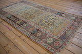 Ochre field with henna plant motif and time-softened border on an antique Kurdish Bijar rug.