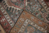 Vintage Northwest Persian rug detail: dusty teal, chestnut red patterns and hand-knotted woven back.