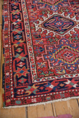 Vintage Karaja corner showing geometric cherry red, navy blue patterns, and polychromatic selvage.