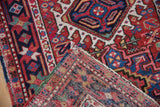 Vintage Karaja rug with cherry red geometric blossoms, its polychromatic selvage, and woven foundation.