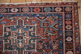 Corner detail of a vintage Karaja showing its floral and leaf main border and hand-knotted pile.