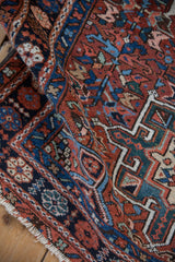 Close-up on the polychromatic floral and leaf border of a hand-knotted vintage Karaja rug.