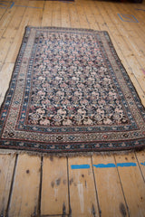 Vintage Kurdish rug detail: intricate boteh lattice with subtle abrashes in dark, blush, and blue tones.