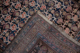 Kurdish rug corner reveals intricate floral pattern and its tightly hand-knotted back.