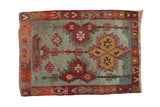 Vintage 1940s Turkish Kilim rug, seafoam green abrashed ground, red geometric medallions, plant border.