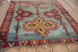 Vintage Turkish Kilim with saffron yellow, red, and seafoam green geometric patterns, showing abrashes.