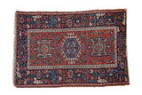 Vintage Karaja rug with a triple center medallion, brick red field, and a geometric navy blue border.