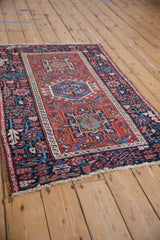 Angled perspective of a vintage Karaja rug, showing its repeating geometric medallions and borders.