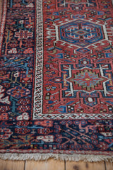 Angled view of a Karaja rug's corner showing the geometric medallion and navy border.