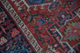 Close-up of the vintage Karaja rug's texture, showing low pile and geometric border details.