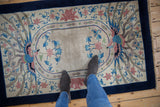 Vintage Art Deco rug with double phoenix motif and soft hand-knotted pile shown for scale.
