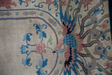Detail of the phoenix pictorial motif in blush and cobalt blue on a hand-knotted Art Deco rug.