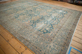 Vintage Indian Agra carpet with distressed ocean blue palmettes on a faded ivory ground.