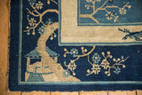 Bottom corner of antique Peking carpet with beige hut, tree, and blue blossoms.