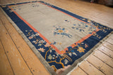 Fetti-Li style floral motifs in cobalt, coral, gold on antique Art Deco carpet border.