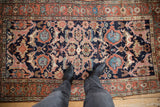 A personal view of an antique Kurdish rug's central field with expressive floral and palmette designs.