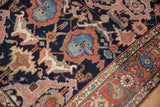 Expressive floral arabesques in terracotta and blue on an antique Kurdish rug's pile.