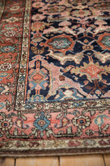 Detail of expressive arabesques in dusty rose and jade green on a collector antique Kurdish rug.