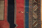 Antique Malayer rug detail: primitive animal figures, cherry red field, and stylized geometric border.
