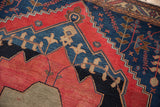 Fine weave Malayer rug detail, primitive cherry red and navy blue geometric motifs.