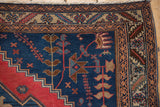 Antique Malayer rug corner, primitive navy and red motifs, intricate beige borders, faint foundation.