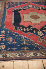 Finely woven border details and primitive stylized motifs on the antique Malayer rug's fringed end.