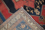 Antique Malayer rug corner showing fine backweave, detailed ivory border, and cherry red pile.