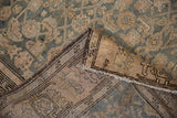 Vintage Malayer rug: distressed teal Herati pattern, tattered edge, exposed foundation.